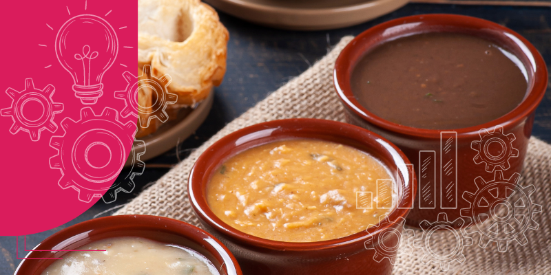 Imagem de uma mesa rústica com seis pratos de inverno, incluindo sopa, ensopado, legumes assados, caçarola, carne grelhada e torta, ideal para inspirar cardápios da estação.