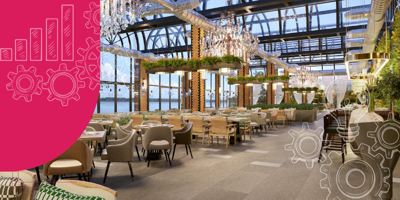 Interior de restaurante aconchegante com mesa de madeira grande, cadeiras confortáveis e plantas em prateleiras iluminadas.